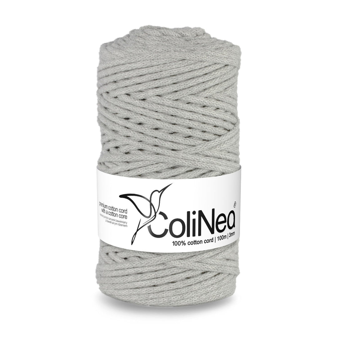 ColiNea presents a braided cotton cord featuring a cotton core, 3mm thick and 100m long, in a soft light gray shade. Ideal for various crafting endeavors, offering durability and subtle sophistication.